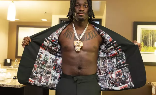 Texas A&amp;M edge rusher Shemar Stewart tries on a suit from designer Baynes + Baker ahead of the NFL Draft, Wednesday, April 23, 2025, in Green Bay, Wis. (AP Photo/Matt Ludtke)
