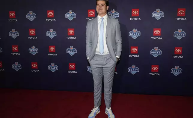 FILE - North Carolina quarterback Drake Maye poses on the red carpet ahead of the first round of the NFL football draft, Thursday, April 25, 2024, in Detroit. (AP Photo/Carlos Osorio, File)