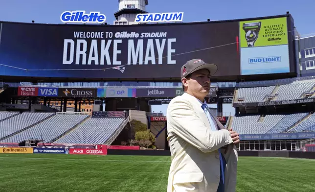 FILE - New England Patriots first round draft pick Drake Maye, a quarterback out of North Carolina, walks on the field during an NFL football press conference, Friday, April 26, 2024, in Foxborough, Mass. (AP Photo/Charles Krupa, File)