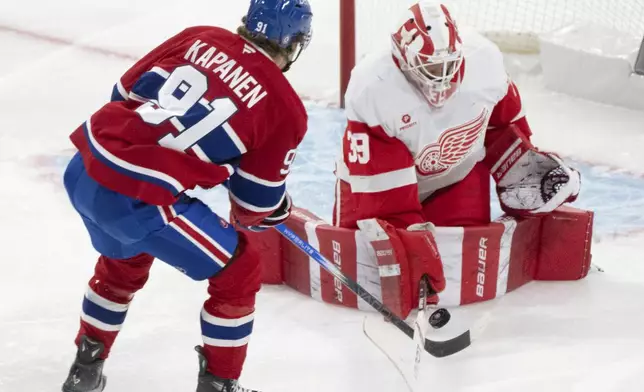 Detroit Red Wings goaltender Cam Talbot (39) stops a shot by Montreal Canadiens' Oliver Kapanen (91) during second period NHL hockey action in Montreal on Tuesday, April 8, 2025. (Christinne Muschi/The Canadian Press via AP)