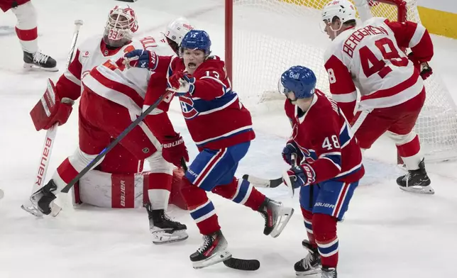 Montreal Canadiens' Cole Caufield (13) celebrates his goal over Detroit Red Wings goaltender Cam Talbot (39) during the second period of an NHL hockey game in Montreal on Tuesday, April 8, 2025. (Christinne Muschi/The Canadian Press via AP)