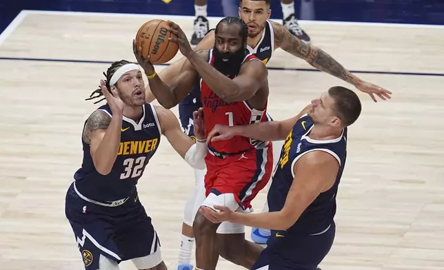 Los Angeles Clippers guard James Harden, center front, looks to pass the ball as Denver Nuggets forward Aaron Gordon (32), forward Michael Porter Jr., center back, and center Nikola Jokic, right, defend in the first half of Game 2 of a first-round NBA playoff series Monday, April 21, 2025, in Denver. (AP Photo/David Zalubowski)