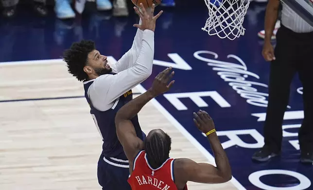 Denver Nuggets guard Jamal Murray, top, drives to the basket as Los Angeles Clippers guard James Harden, bottom, defends in the first half of Game 2 of a first-round NBA playoff series Monday, April 21, 2025, in Denver. (AP Photo/David Zalubowski)