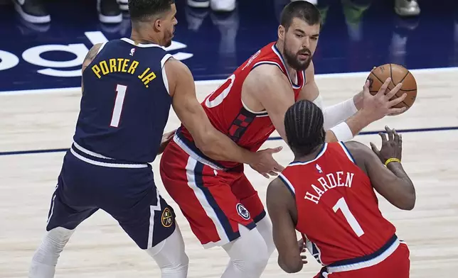 Los Angeles Clippers center Ivica Zubac, top right, looks to pass the ball to guard James Harden, bottom right, as Denver Nuggets forward Michael Porter Jr., left, defends in the first half of Game 2 of a first-round NBA playoff series Monday, April 21, 2025, in Denver. (AP Photo/David Zalubowski)
