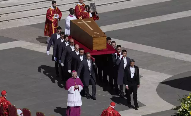 The coffin of Pope Francis is carried into St Peter's Square for his funeral, at the Vatican, Saturday, April 26, 2025. (AP Photo/Gregorio Borgia)
