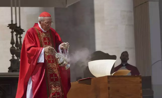 Dean of the College of Cardinals Giovanni Battista Re blesses the coffin during the funeral of Pope Francis in St. Peter's Square at the Vatican, Saturday, April 26, 2025. (AP Photo/Alessandra Tarantino)