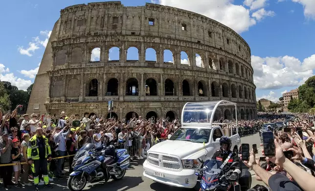 The coffin of Pope Francis is transported in front of the Colosseum on its way to St. Mary Major where he will be buried, Rome, Saturday, April 26, 2025. (Mauro Scrobogna/LaPresse via AP)