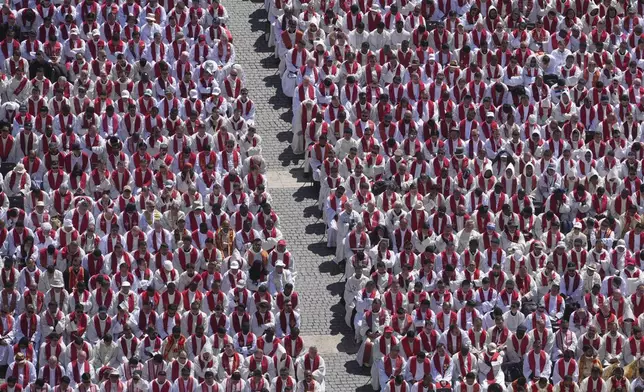Clergy follow the funeral of Pope Francis in St. Peter's Square at the Vatican, Saturday, April 26, 2025. (AP Photo/Alessandra Tarantino)