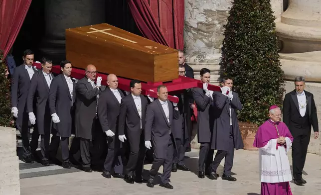 Pallbearers carry the coffin of Pope Francis during his funeral in St. Peter's Square at the Vatican, Saturday, April 26, 2025. (AP Photo/Gregorio Borgia)