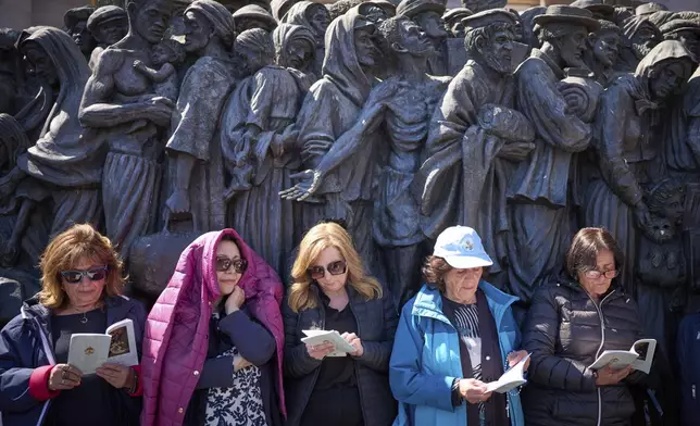 Faithful listen to mass during the funeral of Pope Francis in St. Peter's Square at the Vatican, Saturday, April 26, 2025. (AP Photo/Emilio Morenatti)