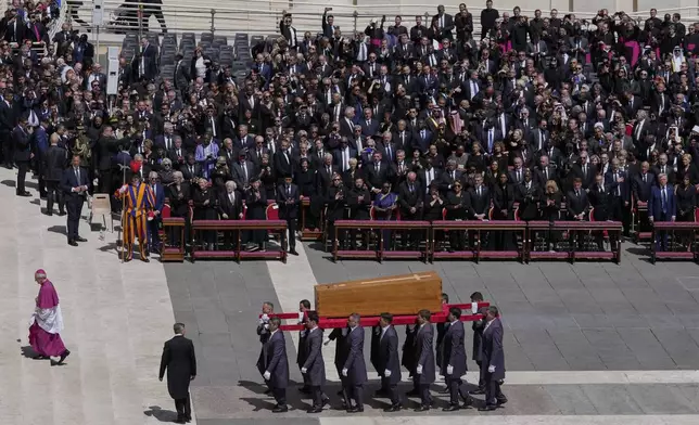 The coffin of Pope Francis is carried in front of dignitaries during his funeral in St. Peter's Square at the Vatican, Saturday, April 26, 2025. (AP Photo/Gregorio Borgia)