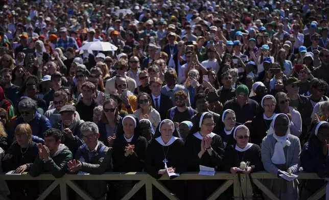 Nuns and faithful listen to mass during the funeral of Pope Francis in St. Peter's Square at the Vatican, Saturday, April 26, 2025. (AP Photo/Emilio Morenatti)