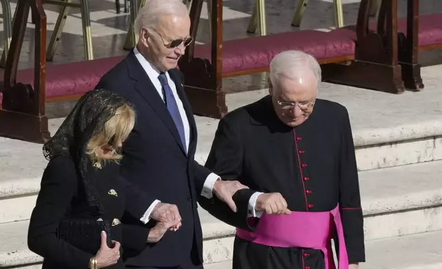 Former President Joe Biden, center, and his wife Jill arrive for the funeral of Pope Francis in St. Peter's Square at the Vatican, Saturday, April 26, 2025. (AP Photo/Gregorio Borgia)