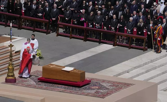 Dean of the College of Cardinals Giovanni Battista Re spreads incense around the coffin of Pope Francis during his funeral in St. Peter's Square at the Vatican, Saturday, April 26, 2025. (AP Photo/Gregorio Borgia)