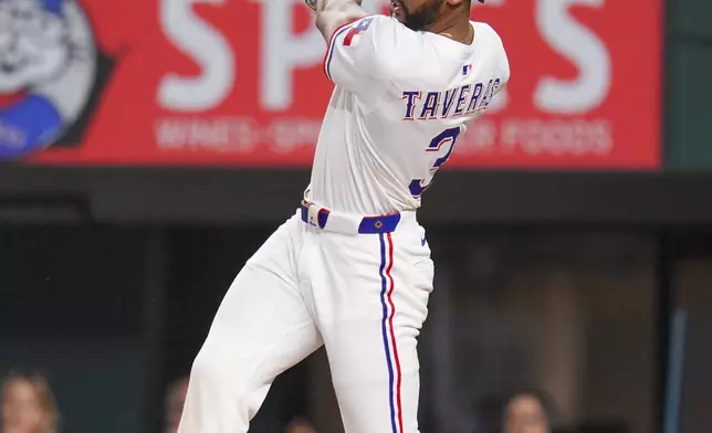 Texas Rangers' Leody Taveras watches his ball as he connects for a two-run double against Los Angeles Angels starting pitcher Jack Kochanowicz during the second inning of a baseball game Thursday, April 17, 2025, in Arlington, Texas. (AP Photo/Julio Cortez)