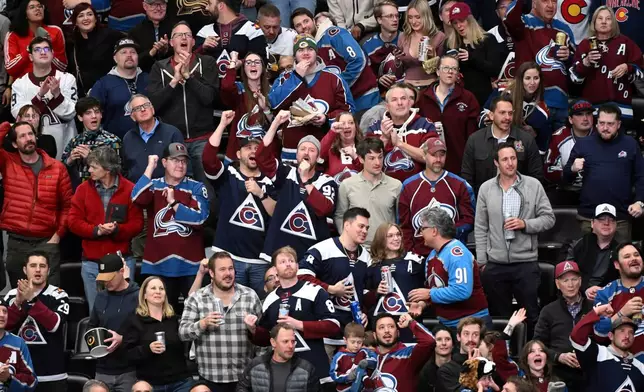 Colorado Avalanche fans cheer after a goal against the Vegas Golden Knights in the second period of an NHL hockey game Tuesday, April 8, 2025, in Denver. (AP Photo/Geneva Heffernan)
