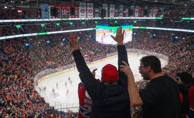 Montreal Canadiens fans react after a goal over the Carolina Hurricanes during first period NHL hockey action in Montreal on Wednesday, April 16, 2025. (Christinne Muschi/The Canadian Press via AP)