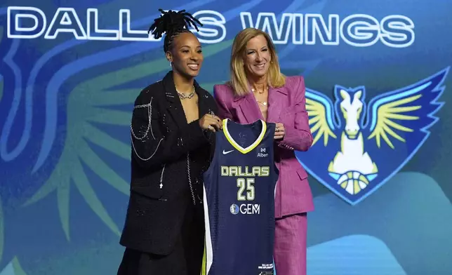 North Caroline State's Aziaha James, left, poses for a photo with WNBA commissioner Cathy Engelbert after being selected 12th overall by the Dallas Wings during the first round of the WNBA basketball draft, Monday, April 14, 2025, in New York. (AP Photo/Pamela Smith)