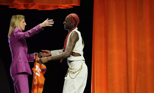 North Carolina State's Saniya Rivers, right, embraces WNBA commissioner Cathy Engelbert after being selected eighth overall by the Connecticut Sun during the first round of the WNBA basketball draft, Monday, April 14, 2025, in New York. (AP Photo/Pamela Smith)