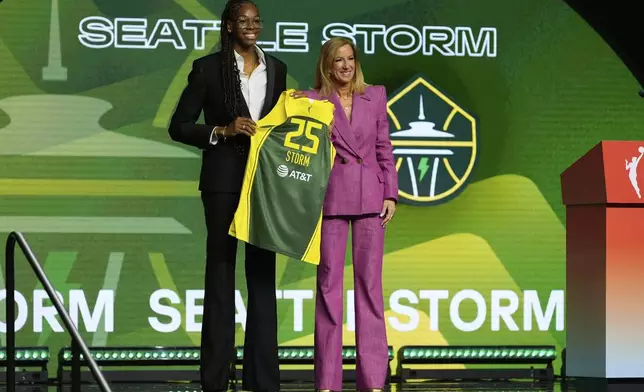 Dominique Malonga, left, poses with WNBA commissioner Cathy Engelbert after being selected second overall by the Seattle Storm during the first round of the WNBA basketball draft, Monday, April 14, 2025, in New York. (AP Photo/Pamela Smith)