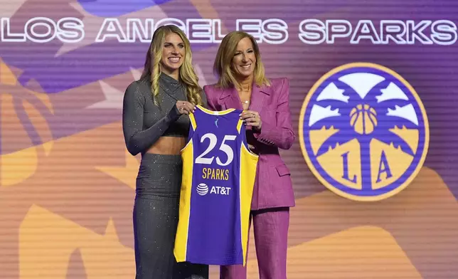 Alabama's Sarah Ashlee Barker, left, poses for a photo with WNBA commissioner Cathy Engelbert after being selected ninth overall by the Los Angeles Sparks during the first round of the WNBA basketball draft, Monday, April 14, 2025, in New York. (AP Photo/Pamela Smith)