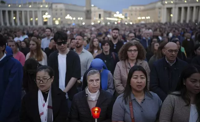Faithful gather for a rosary prayer for the late Pope Francis, in St. Peter's Square at the Vatican, Monday April 21, 2025 (AP Photo/Alessandra Tarantino)