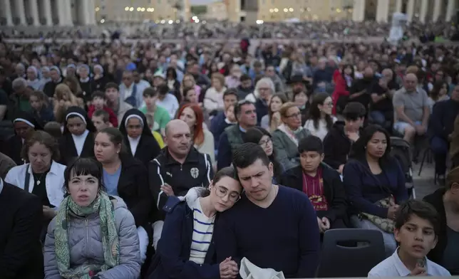 Faithful gather for a rosary prayer for the late Pope Francis, in St. Peter's Square at the Vatican, Monday April 21, 2025. (AP Photo/Alessandra Tarantino)