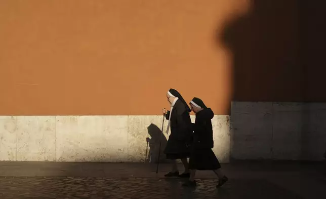 Nuns walk to Vatican City, Tuesday, April 22, 2025. (AP Photo/Francisco Seco)