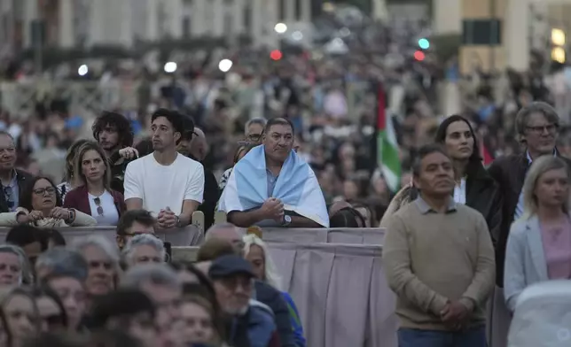 Faithful gather for a rosary prayer for the late Pope Francis, in St. Peter's Square at the Vatican, Monday April 21, 2025. (AP Photo/Alessandra Tarantino)
