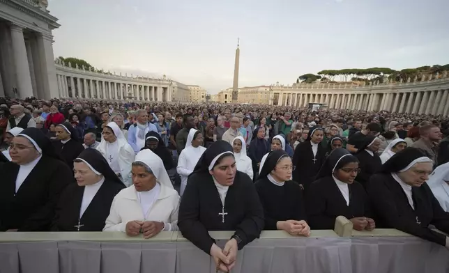 Faithful gather for a rosary prayer for the late Pope Francis, in St. Peter's Square at the Vatican, Monday April 21, 2025. (AP Photo/Alessandra Tarantino)