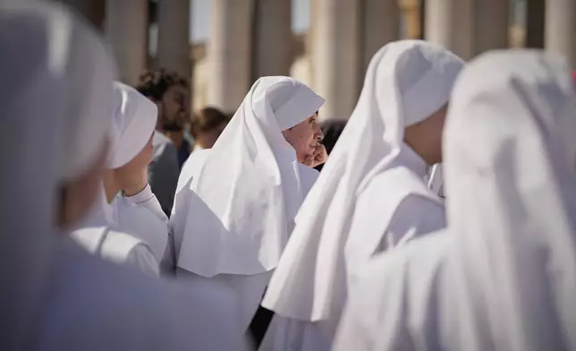 Nuns wait in St. Peter's Square to pay their respect to the late Pope Francis, who will lie in state at St. Peter's Basilica for three days, at the Vatican, Wednesday, April 23, 2025. (AP Photo/Andreea Alexandru)