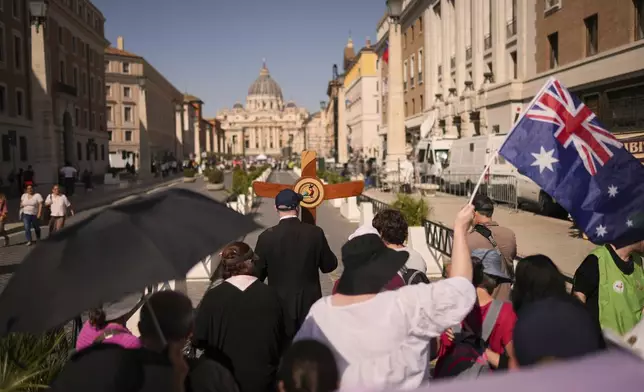 Australian pilgrims walk to St. Peter's Square at the Vatican,Tuesday, April 22, 2025. (AP Photo/Francisco Seco)