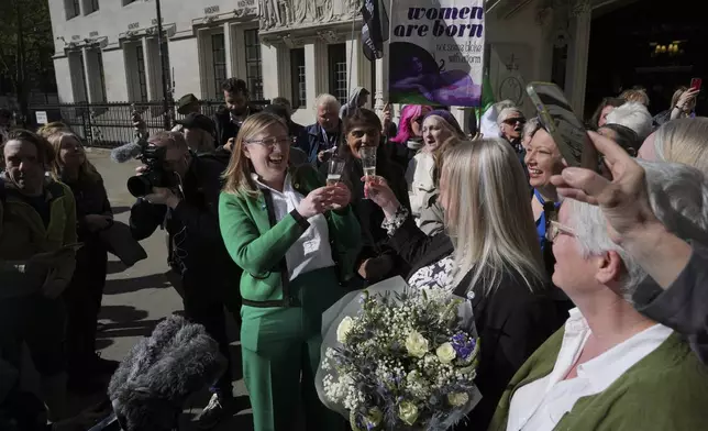 Marion Calder and Susan Smith from For Women Scotland, celebrate outside the Supreme Court to challenge gender recognition laws, in London, Wednesday, April 16, 2025. (AP Photo/Kin Cheung)