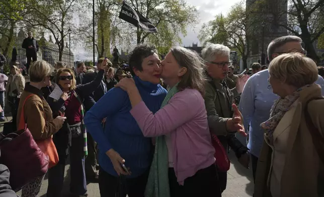 Women's rights activists celebrate outside the Supreme Court to challenge gender recognition laws, in London, Wednesday, April 16, 2025. (AP Photo/Kin Cheung)