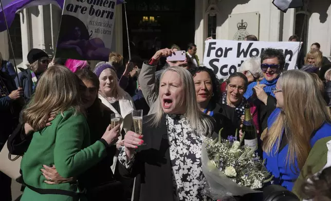 Marion Calder and Susan Smith from For Women Scotland, celebrate outside the Supreme Court to challenge gender recognition laws, in London, Wednesday, April 16, 2025. (AP Photo/Kin Cheung)