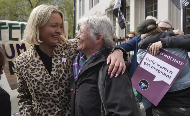Women's rights activists celebrate outside the Supreme Court to challenge gender recognition laws, in London, Wednesday, April 16, 2025. (AP Photo/Kin Cheung)