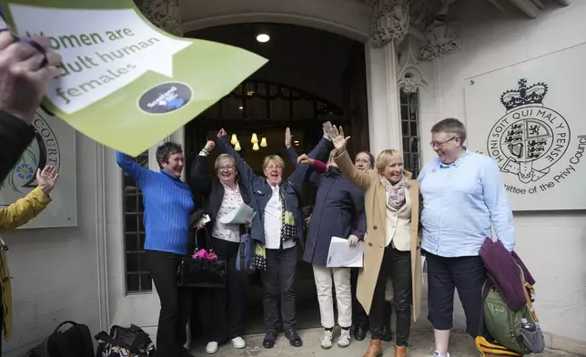 Women's rights activists celebrate outside the Supreme Court to challenge gender recognition laws, in London, Wednesday, April 16, 2025. (AP Photo/Kin Cheung)