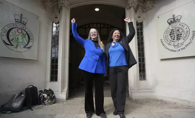 Women's rights activists celebrate outside the Supreme Court to challenge gender recognition laws, in London, Wednesday, April 16, 2025. (AP Photo/Kin Cheung)