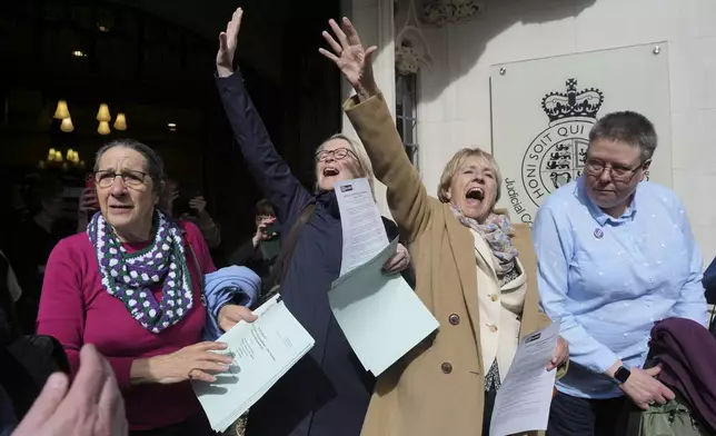 Women's rights activists celebrate outside the Supreme Court to challenge gender recognition laws, in London, Wednesday, April 16, 2025. (AP Photo/Kin Cheung)