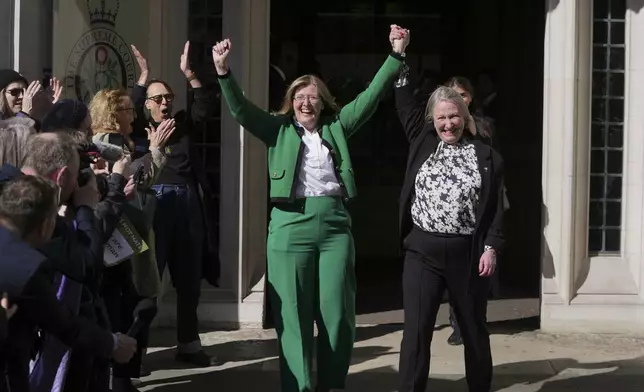 Marion Calder and Susan Smith from For Women Scotland, celebrate outside the Supreme Court to challenge gender recognition laws, in London, Wednesday, April 16, 2025. (AP Photo/Kin Cheung)