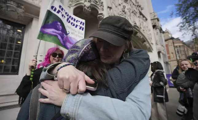 Women's rights activists celebrate outside the Supreme Court to challenge gender recognition laws, in London, Wednesday, April 16, 2025. (AP Photo/Kin Cheung)