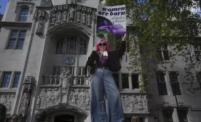 Women's rights activist celebrates outside the Supreme Court to challenge gender recognition laws, in London, Wednesday, April 16, 2025. (AP Photo/Kin Cheung)