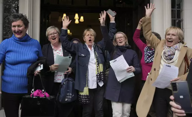 Women's rights activists celebrate outside the Supreme Court to challenge gender recognition laws, in London, Wednesday, April 16, 2025. (AP Photo/Kin Cheung)