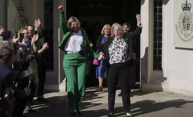 Marion Calder and Susan Smith from For Women Scotland, celebrate outside the Supreme Court to challenge gender recognition laws, in London, Wednesday, April 16, 2025. (AP Photo/Kin Cheung)