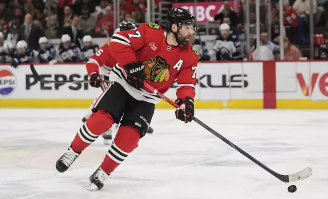 Chicago Blackhawks left wing Patrick Maroon (77) handles the puck during the second period of an NHL hockey game against the Winnipeg Jets, Saturday, April 12, 2025, in Chicago. (AP Photo/Erin Hooley)