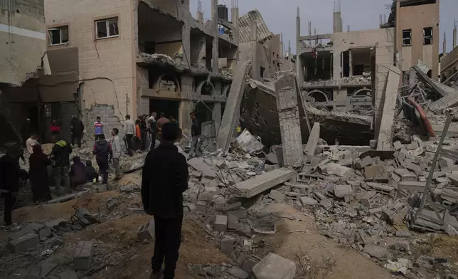 Palestinians inspect the damage caused by an Israeli army airstrike in Khan Younis, Gaza Strip, Tuesday, April 22, 2025. (AP Photo/Abdel Kareem Hana)