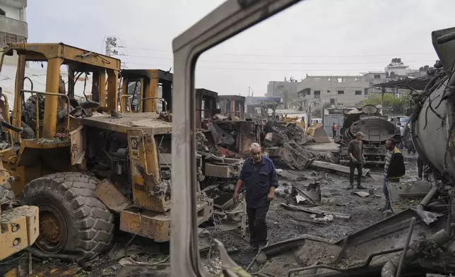 Palestinians examine the remains of bulldozers hit by an Israeli army airstrike in Jabaliya, northern Gaza Strip, on Tuesday, April 22, 2025. (AP Photo/Jehad Alshrafi)