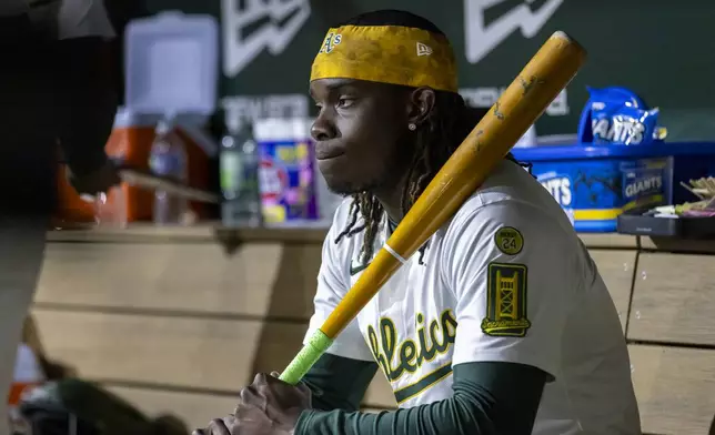 Athletics' Lawrence Butler (4) sits in the dugout during the seventh inning of a baseball game against the Chicago White Sox Friday, April 25, 2025, in West Sacramento, Calif. (AP Photo/Sara Nevis)
