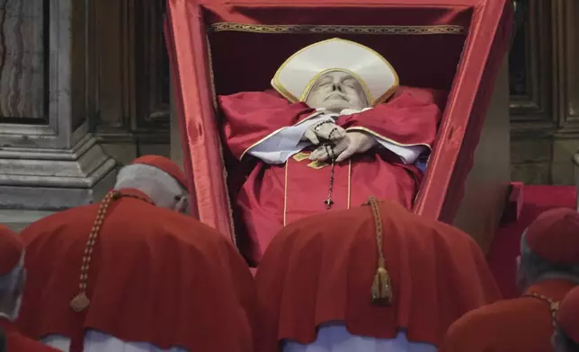 Cardinals pay their respects to Pope Francis inside St. Peter's Basilica at the Vatican, Wednesday, April 23, 2025, where his body will lie in state for three days. (AP Photo/Andrew Medichini, Pool)