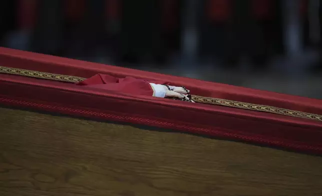 The body of Pope Francis inside St. Peter's Basilica at the Vatican, Wednesday, April 23, 2025, where he will lie in state for three days. (AP Photo/Alessandra Tarantino)